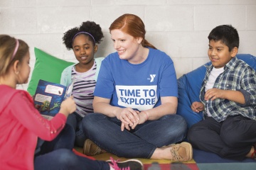 Adult reading a book with kids