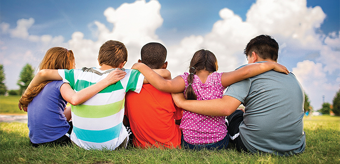 Children sitting with their arms around each other