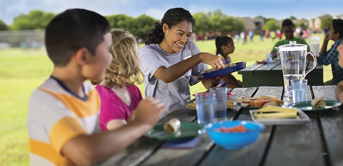 Kids sitting at a picnic table